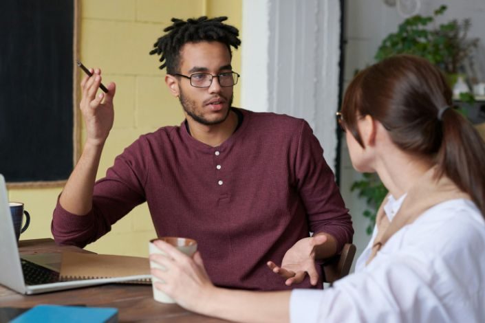 Two people having a difficult conversation at work