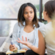 two young women sitting opposite each other having a performance review